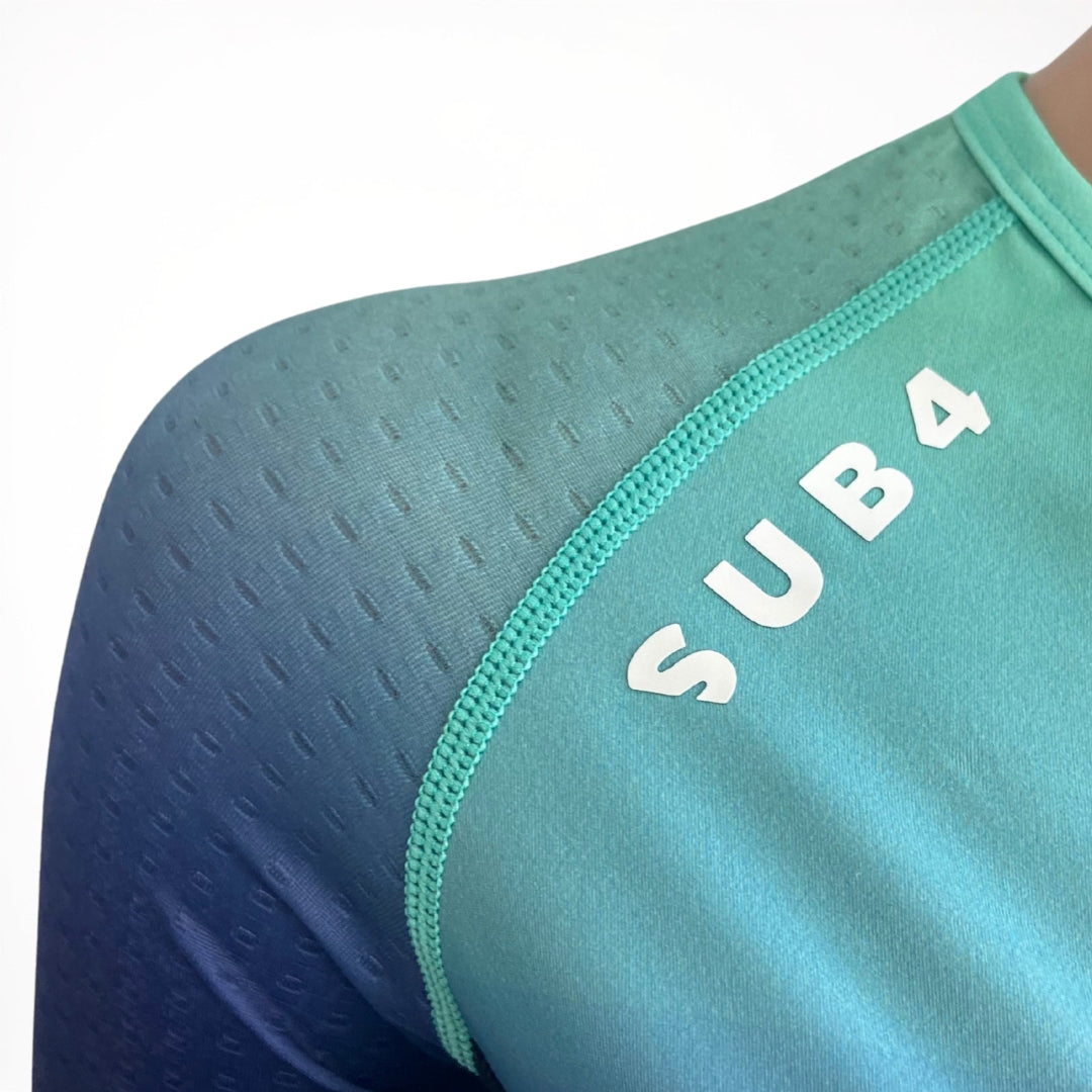 Teal Tri Suit material close up with 'SUB4' branding on a white background