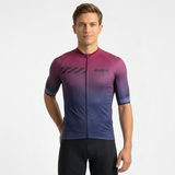 Man wearing a gradient cycling jersey on a plain background