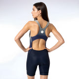 Woman wearing a racerback tri suit on a white background