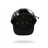 A black and grey running cap with a small white 'SUB4' logo patch on the side, shown floating against a white background with a soft shadow underneath.