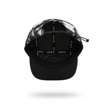 A black and grey running cap with a small white 'SUB4' logo patch on the side, shown floating against a white background with a soft shadow underneath.