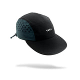 A black and coal teal running cap with a small white 'SUB4' logo patch on the side, shown floating against a white background with a soft shadow underneath.