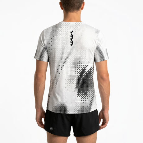 Back view of person wearing a light grey running t-shirt with black patterns and black running shorts on a white background