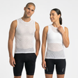 Man and woman wearing matching white sleeveless cycling base layer tops and black cycling shorts on a white background