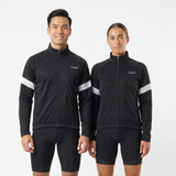 Person wearing black cycling jersey and shorts with white reflective accents on a light gray background