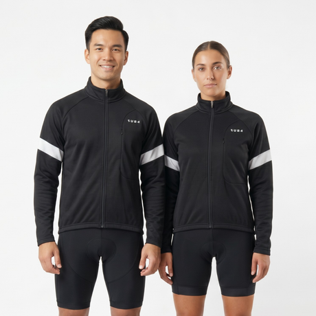 Person wearing black cycling jersey and shorts with white reflective accents on a light gray background
