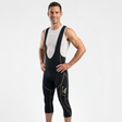 Man wearing a classic black cycling bib shorts on a white background