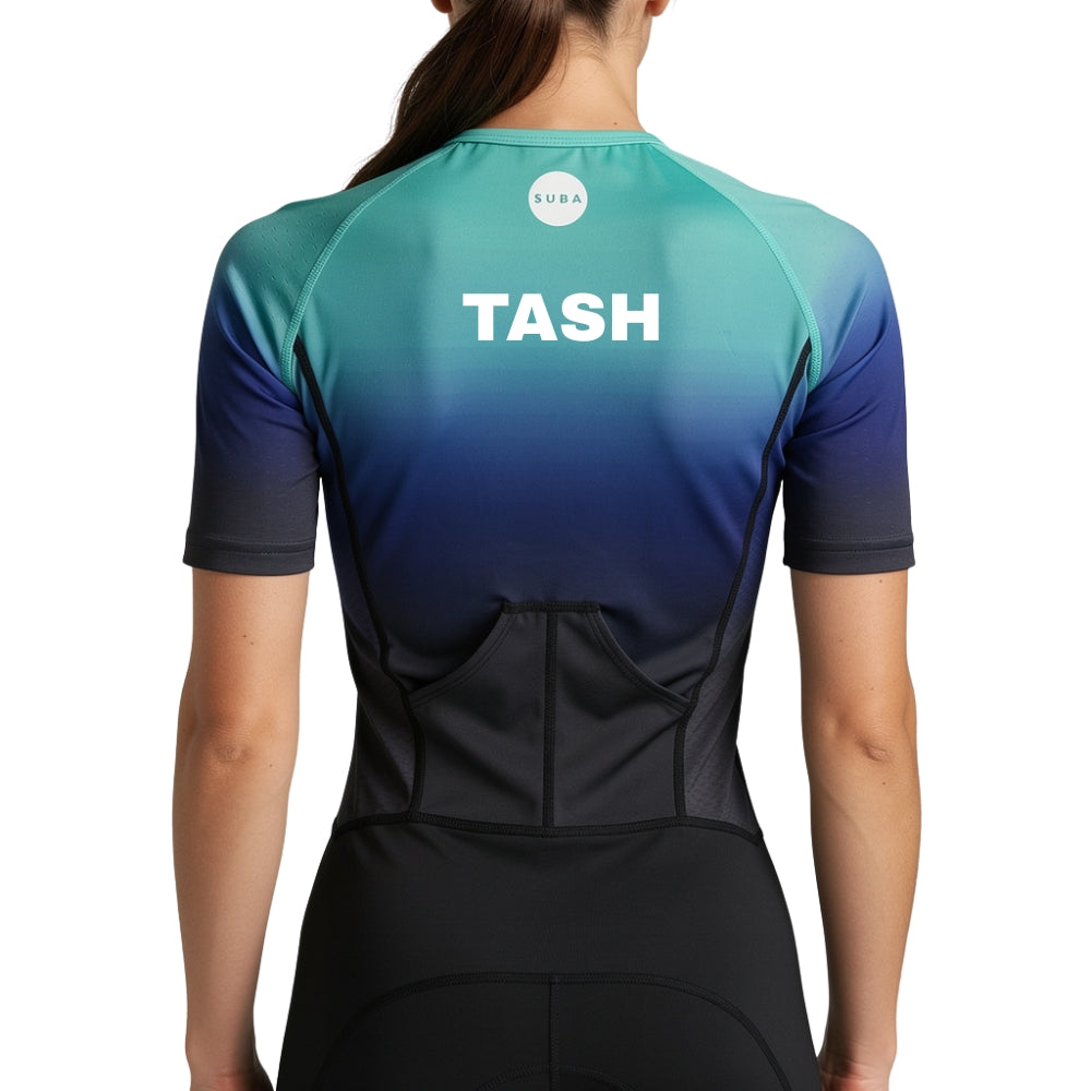 Person wearing a gradient trisuit with 'TASH' personalised name print on a light gray background