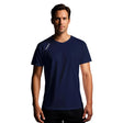 Man wearing a navy blue t-shirt with a brand logo on a gray background
