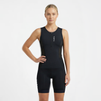 Woman wearing a black sleeveless athletic triathlon top and triathlon shorts on a white background