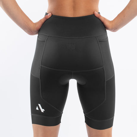 Black athletic triathlon shorts worn by a woman on a white background