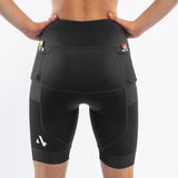 Black athletic triathlon shorts worn by a woman on a white background