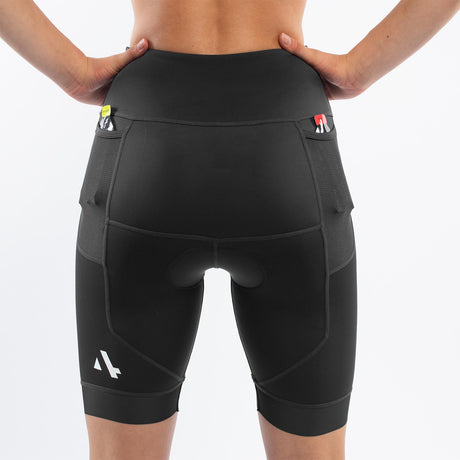 Black athletic triathlon shorts worn by a woman on a white background