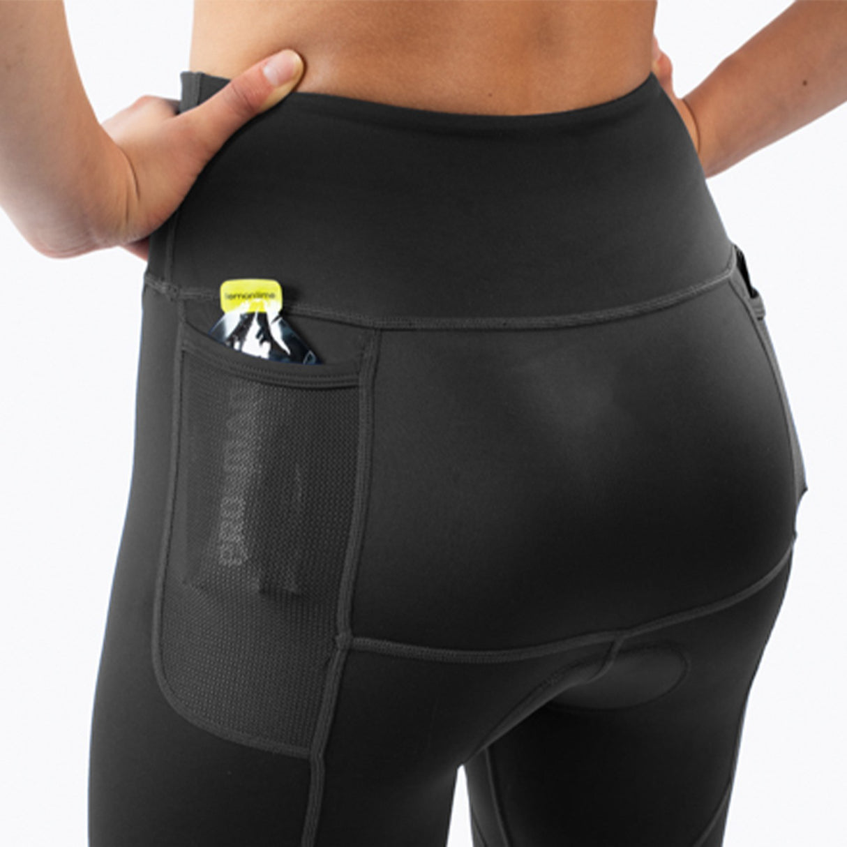 Black athletic triathlon shorts worn by a woman on a white background