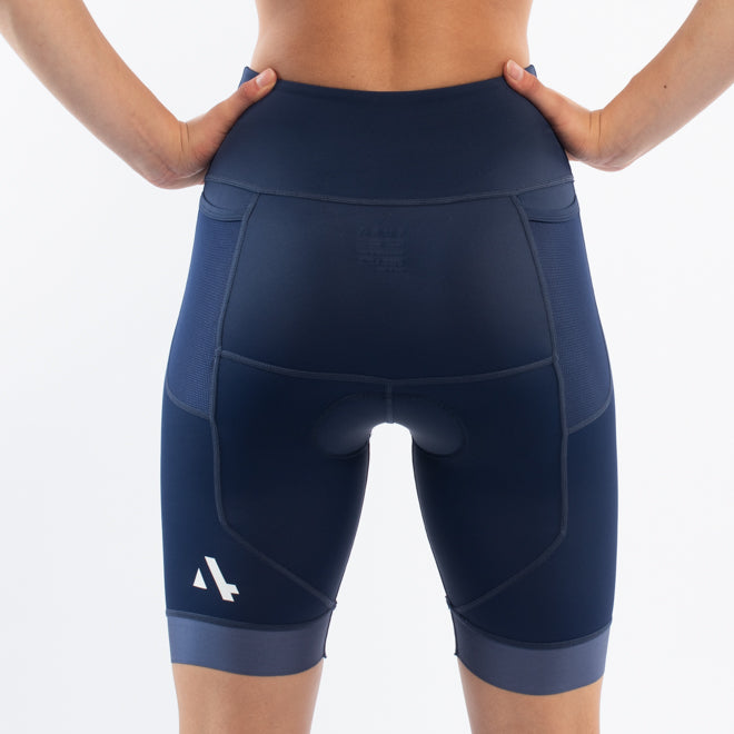 Navy blue athletic triathlon shorts worn by a person on a white background