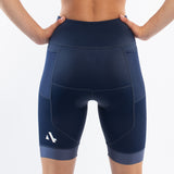 Navy blue athletic triathlon shorts worn by a person on a white background