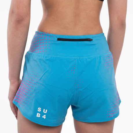 Blue athletic shorts with pink geometric design and 'SUB4' branding on a white background  