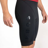 Black Tri suit shorts with a brand logo on a white background