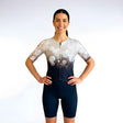 Woman wearing a Triathlon suit with a white and black gradient design on a plain background