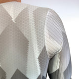 Close-up of a textured fabric with geometric pattern on a white background