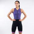 Woman wearing a purple and black triathlon suit on a white background