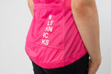 Person wearing a bright pink sleeveless top with '#LEKNICKS' text on a light gray background