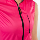 Close-up of a bright pink sleeveless jacket with a zipper on a white background