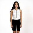 Woman wearing a white sleeveless Triathlon suit with a zipper and black shorts on a white background