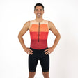 Man wearing a red, orange, and black triathlon suit on a white background