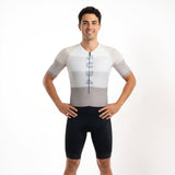 Man wearing a white and grey Triathlon suit on a white background