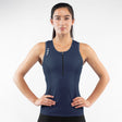 Woman wearing a navy blue Triathlon tank top with a zipper on a white background
