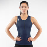 Woman wearing a navy blue Triathlon tank top with a zipper on a white background