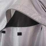Close-up of a gray raincoat with black interior lining and reflective stripes.
